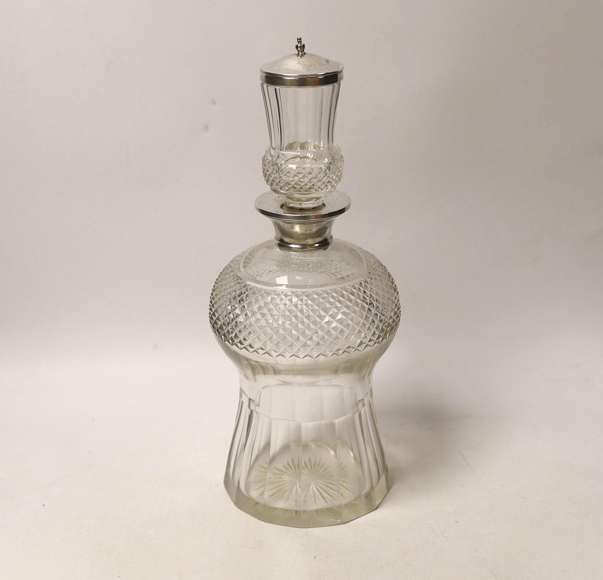 A George V silver mounted cut glass thistle shaped decanter and stopper, Wolfsky & Co Ltd, London, 1927, 29.5cm.